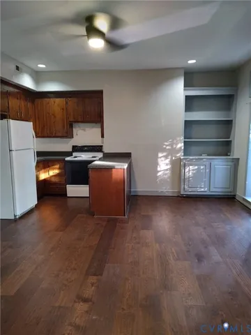 a view of kitchen with stove and refrigerator