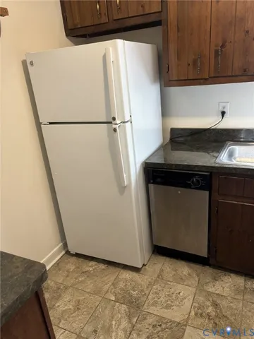 a kitchen with a refrigerator and a sink