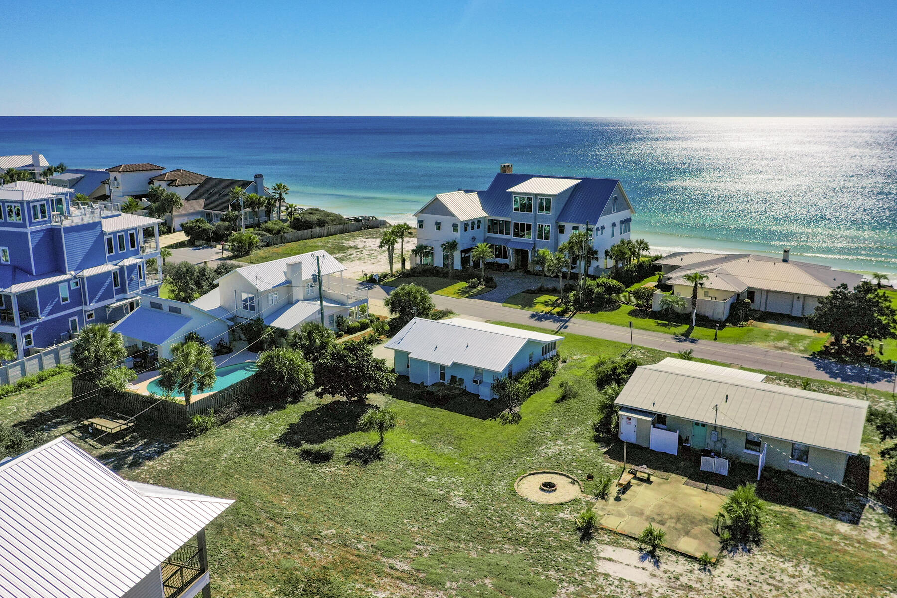 545 Blue Mountain Road Santa Rosa Beach, FL 32459 - Photo 1 of 27 an aerial view of a house with a garden and lake view
