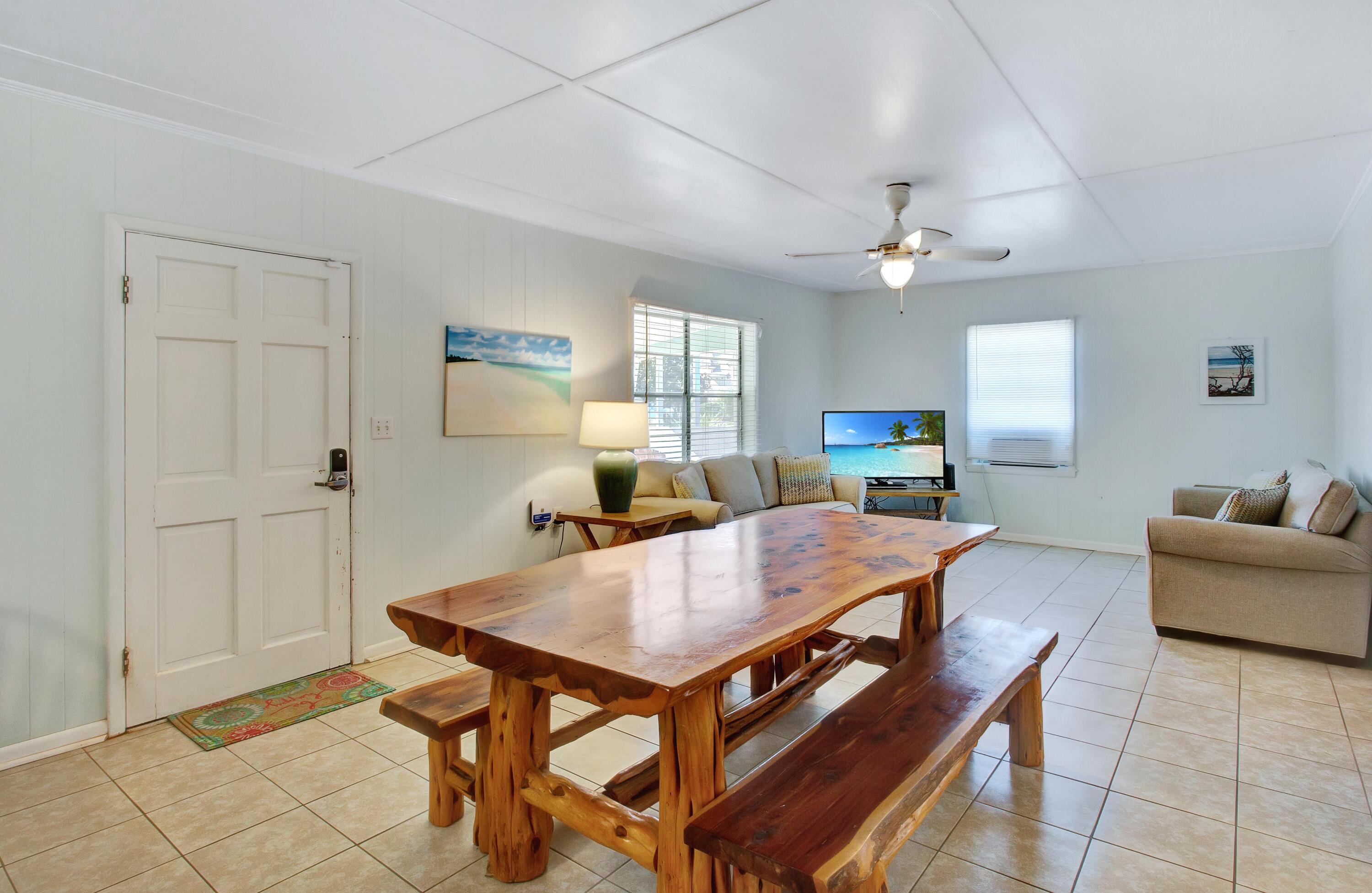 545 Blue Mountain Road Santa Rosa Beach, FL 32459 - Photo 5 of 27 a living room with furniture a table and wooden floor