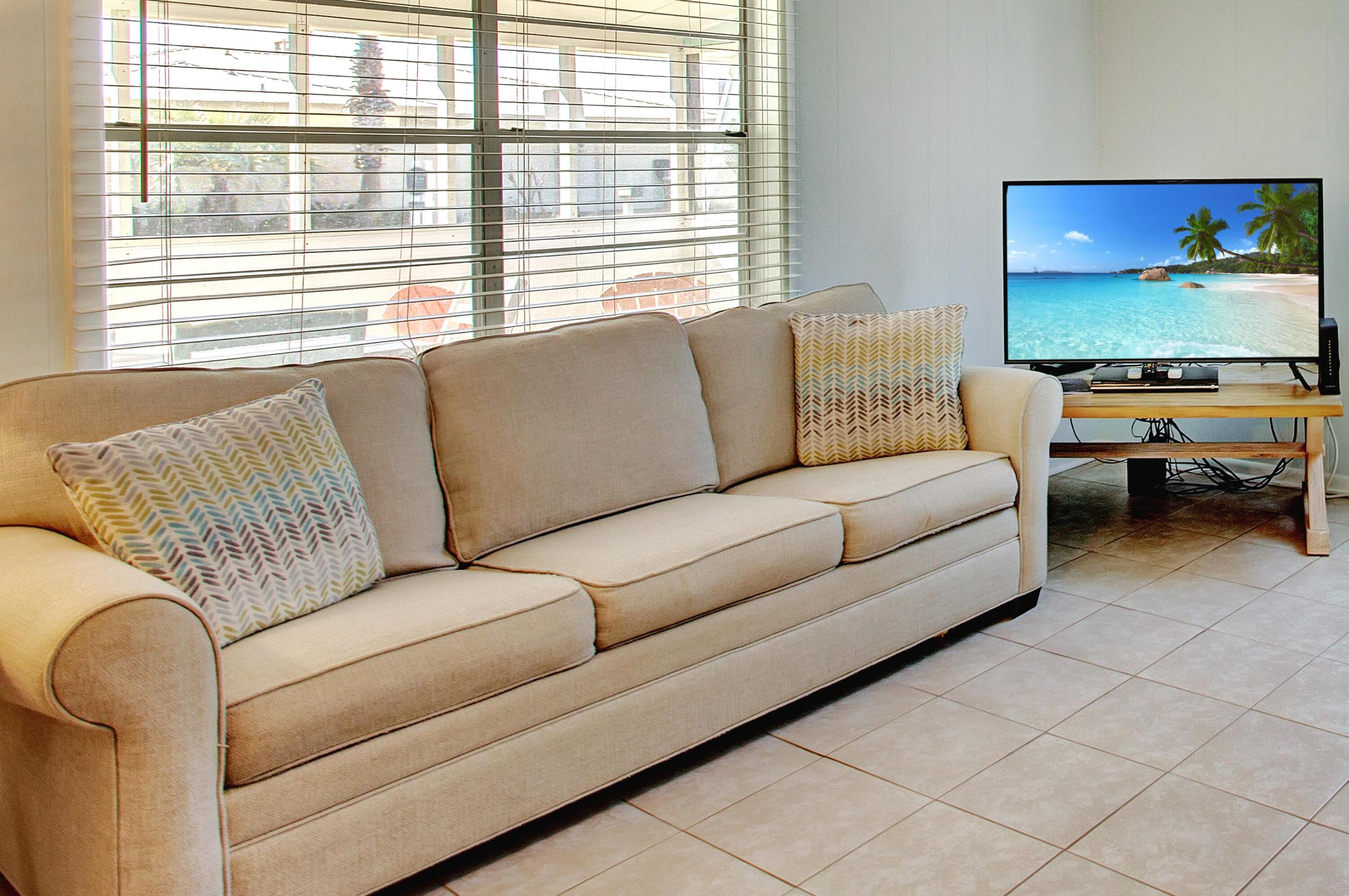 545 Blue Mountain Road Santa Rosa Beach, FL 32459 - Photo 6 of 27 a living room with furniture and a flat screen tv