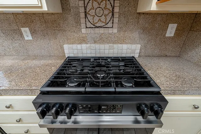 a close view of a stove a microwave and cabinets in the kitchen