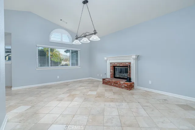 a view of a room with window and chandelier