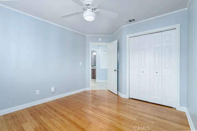 a view of an empty room with wooden floor