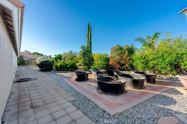 a view of a backyard with plants and patio