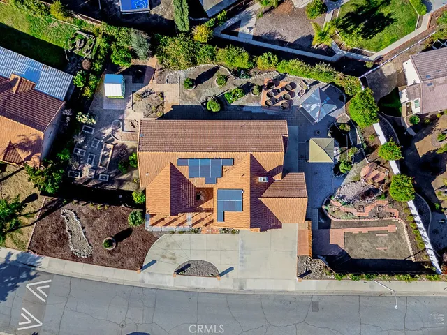 an aerial view of a house with a garden and parking