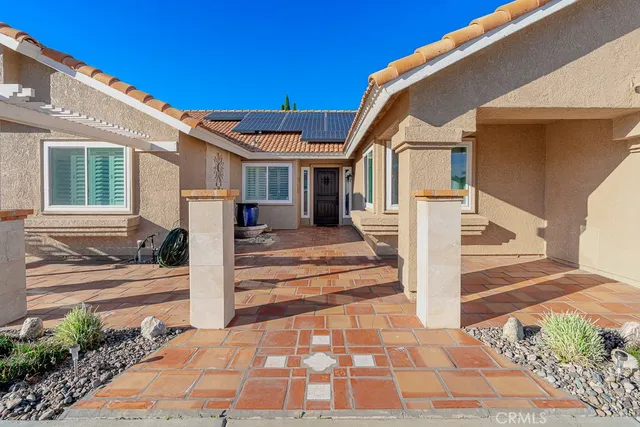 a front view of a house with a fountain
