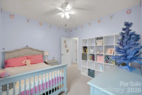 a bedroom with furniture and a large window