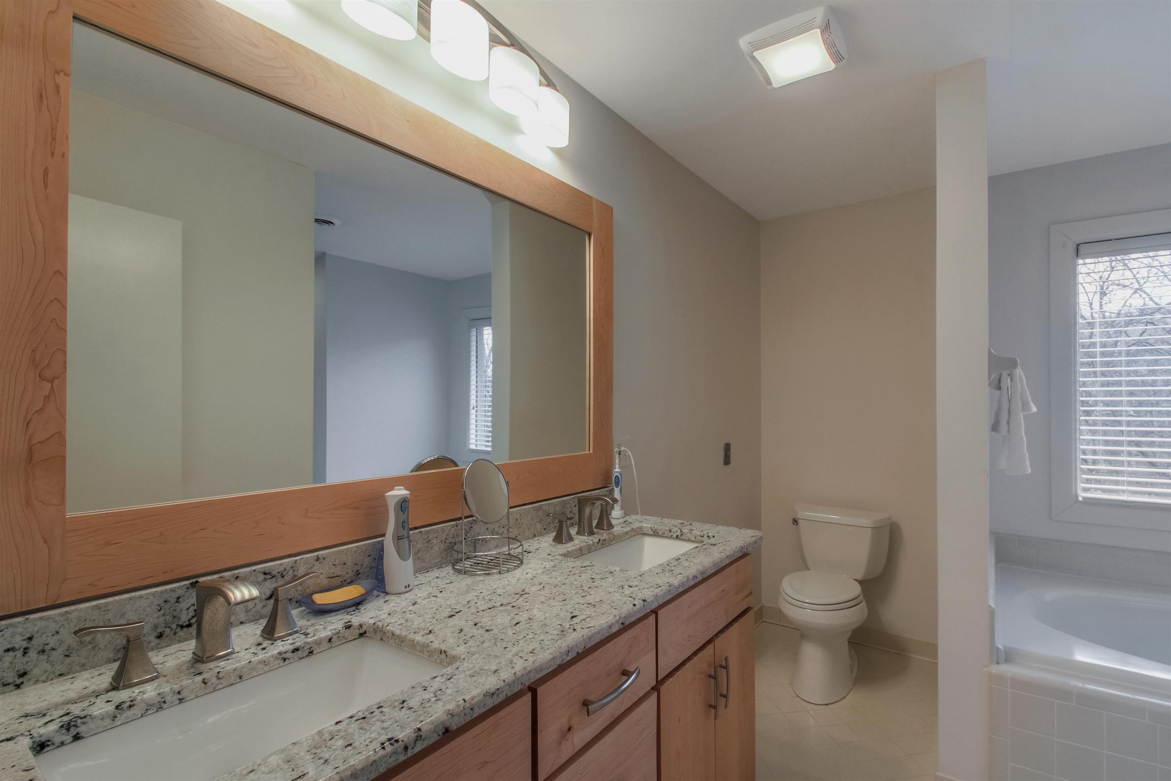 788 High Point Ridge Road Franklin, TN 37069 - Photo 26 of 30 a bathroom with a granite countertop toilet a sink and a mirror