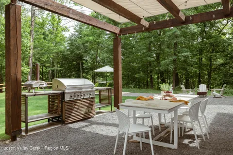 a view of a patio with a dining table and chairs