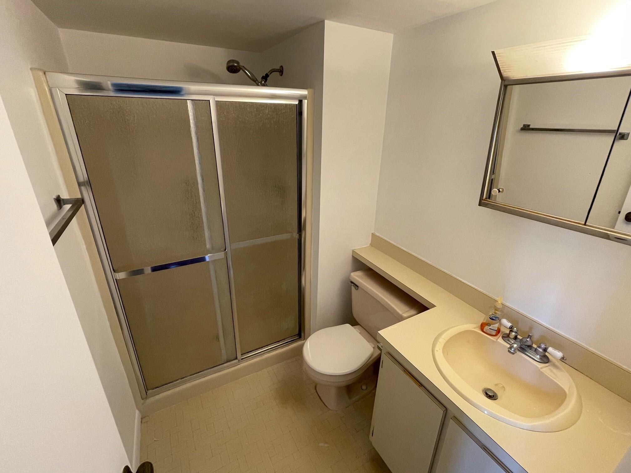 6485 Chasewood Drive, Unit C Jupiter, FL 33458 - Photo 12 of 23 a bathroom with a sink toilet and shower