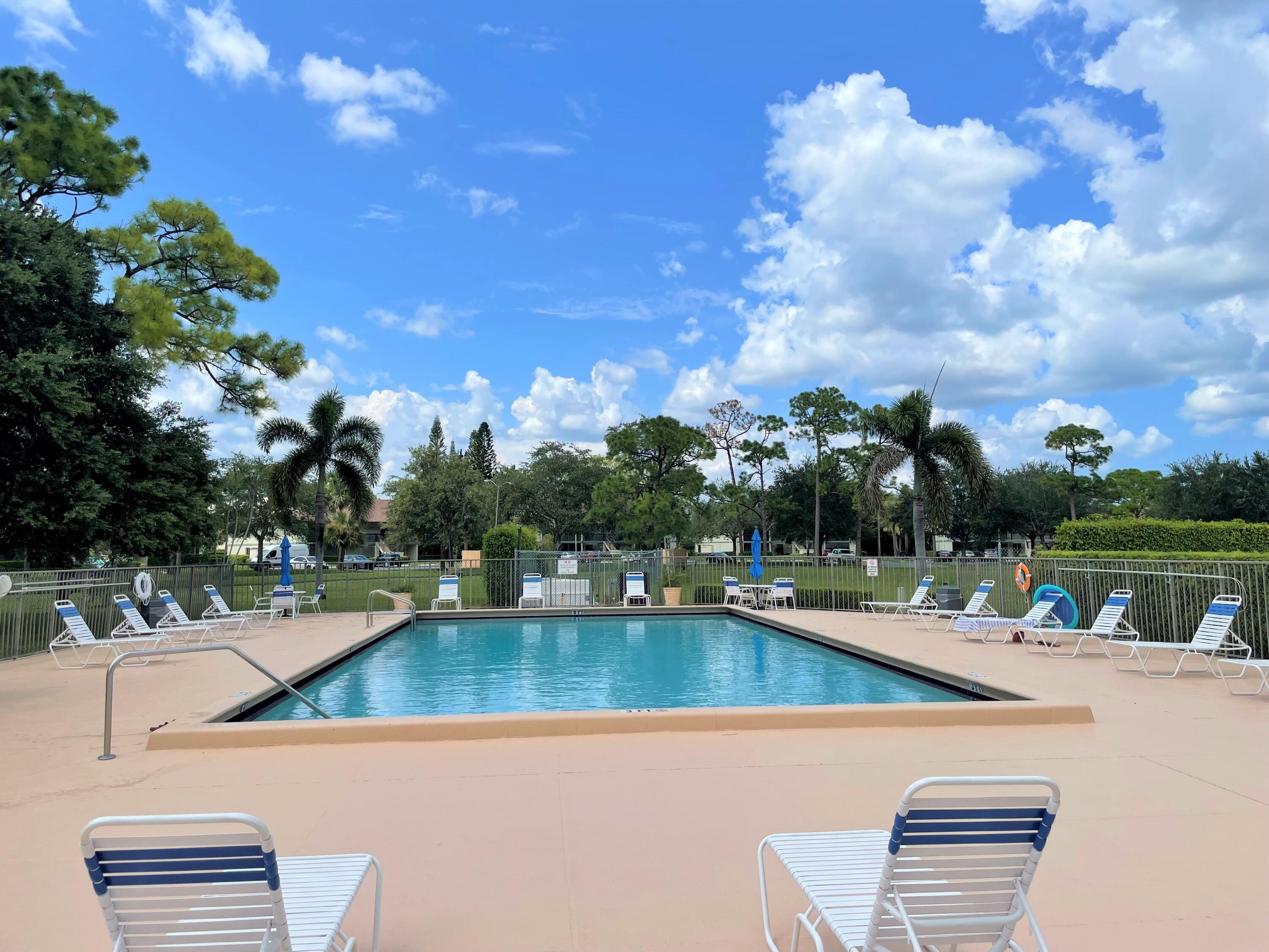 6485 Chasewood Drive, Unit C Jupiter, FL 33458 - Photo 20 of 23 a view of a lake with couches and wooden floor