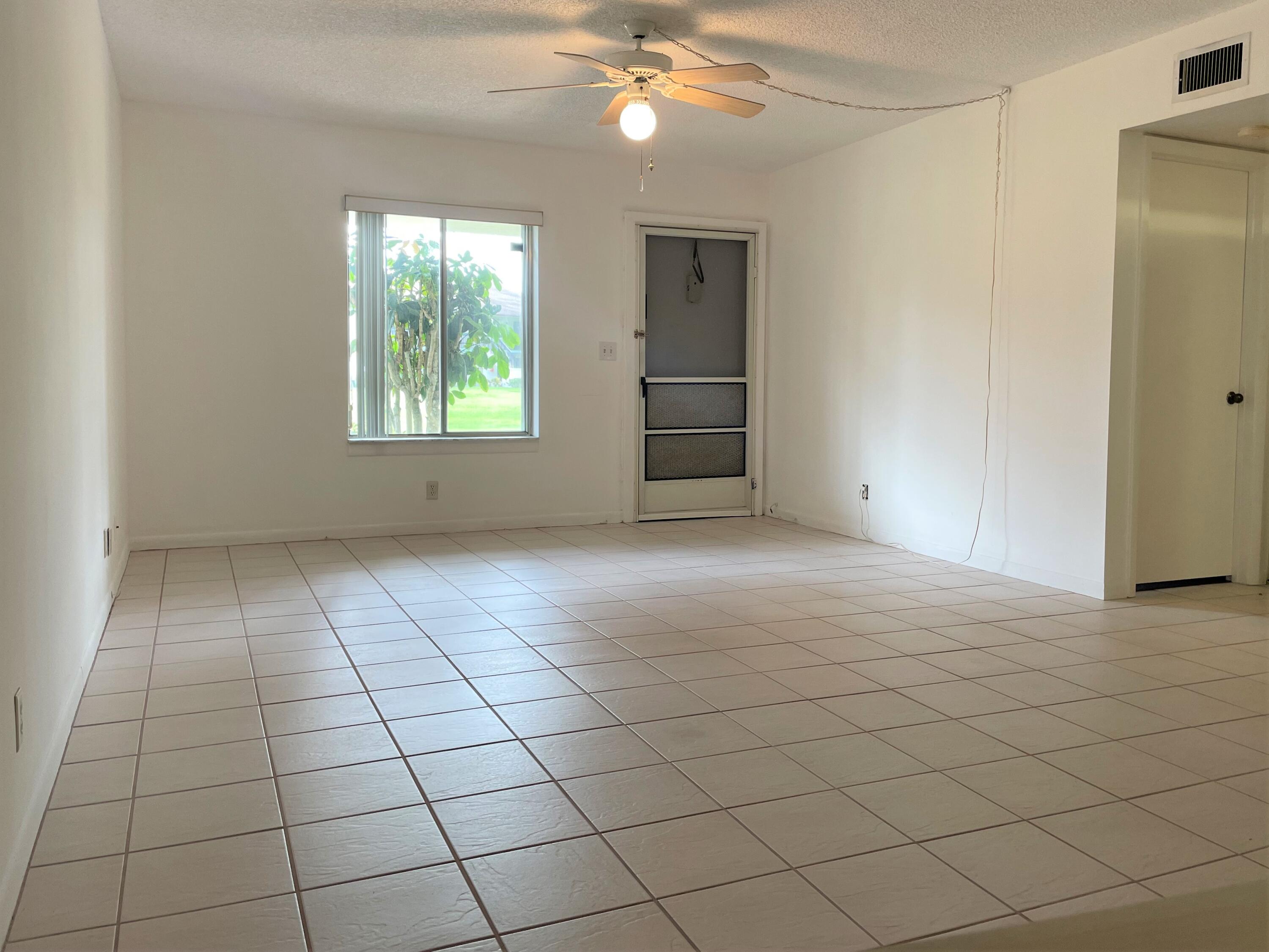 6485 Chasewood Drive, Unit C Jupiter, FL 33458 - Photo 4 of 23 an empty room with windows and closet