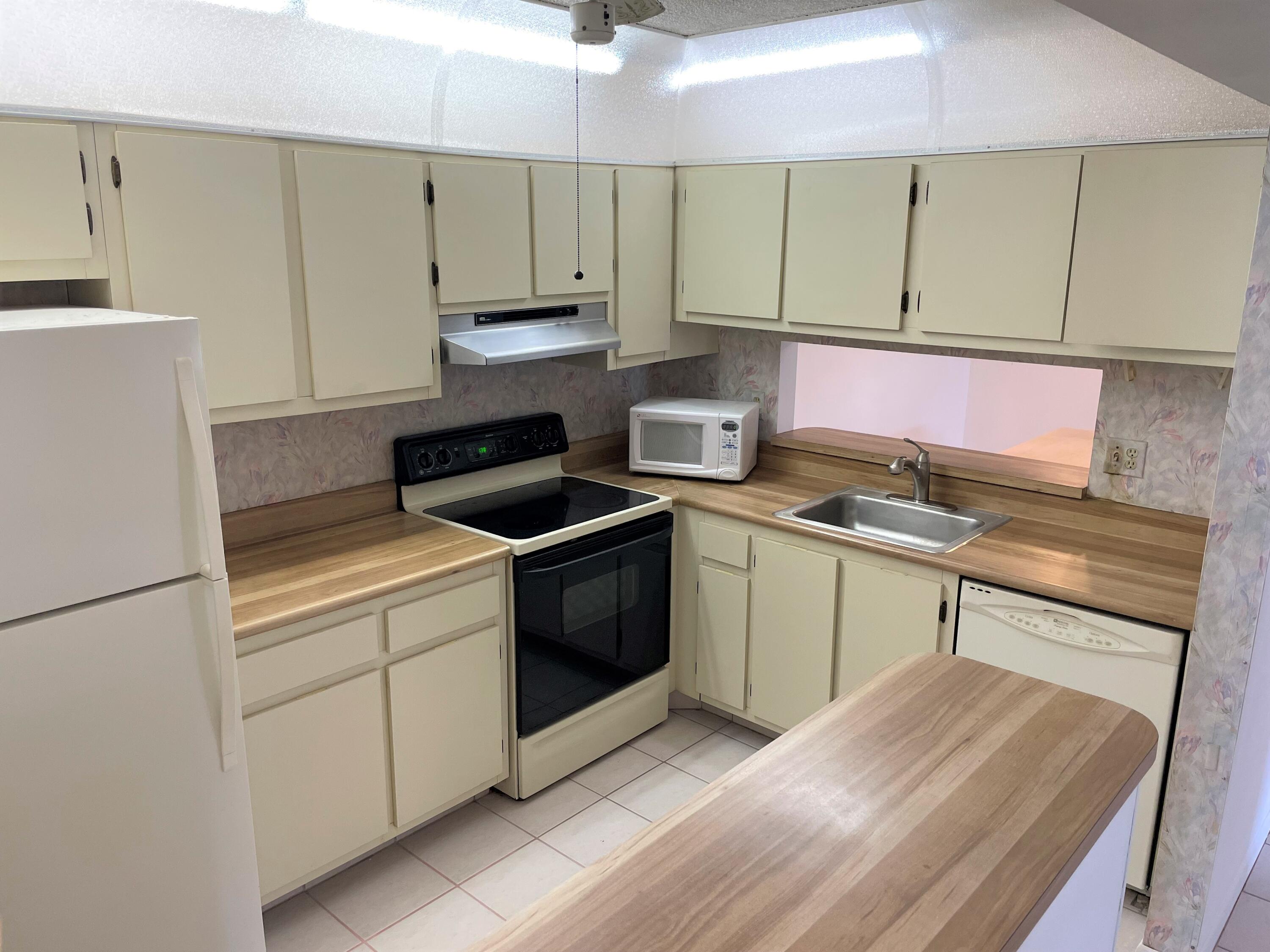 6485 Chasewood Drive, Unit C Jupiter, FL 33458 - Photo 8 of 23 a kitchen with a sink cabinets and appliances