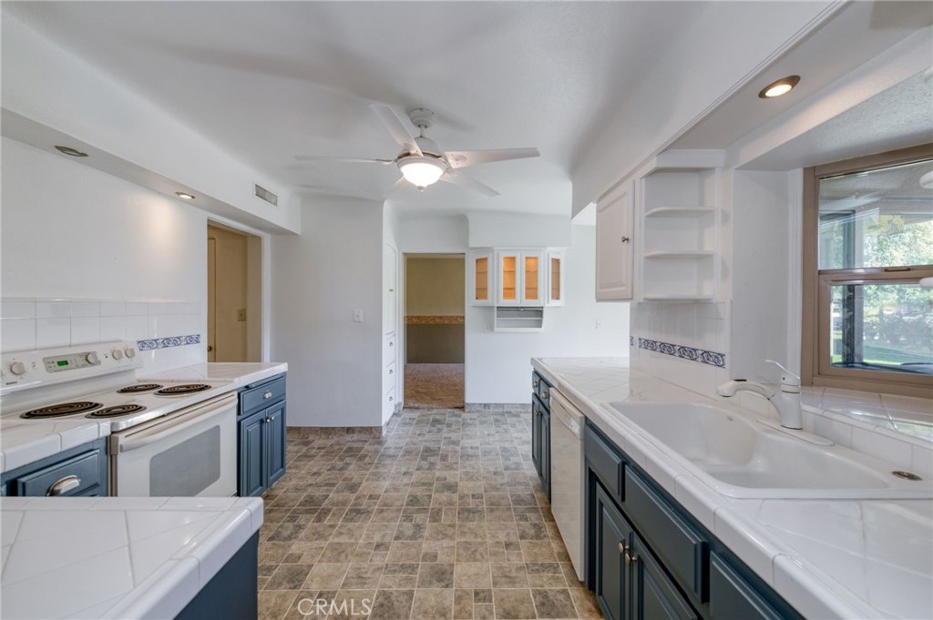 610 Park Madera, CA 93637 - Photo 15 of 35 a kitchen with a stove sink and a refrigerator