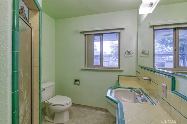a bathroom with a sink toilet and mirror