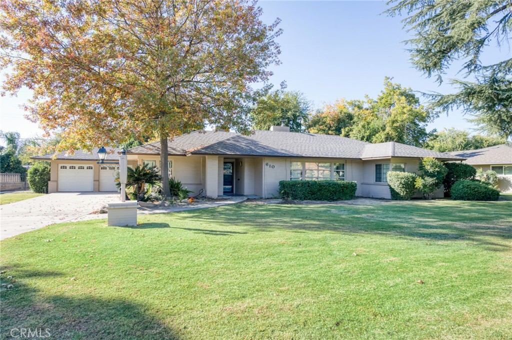 610 Park Madera, CA 93637 - Photo 3 of 35 a front view of a house with a yard and trees