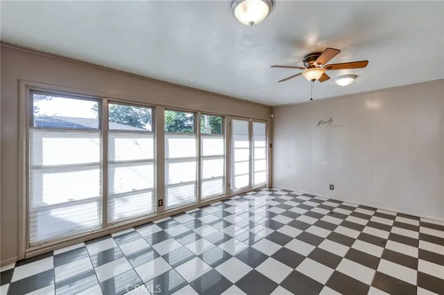 a view of a livingroom with a ceiling fan and window