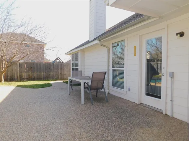 a view of a backyard with swimming pool