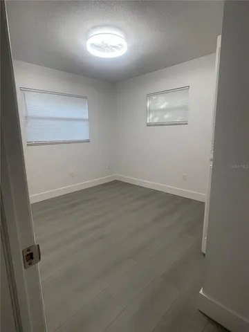 an empty room with a empty space and windows