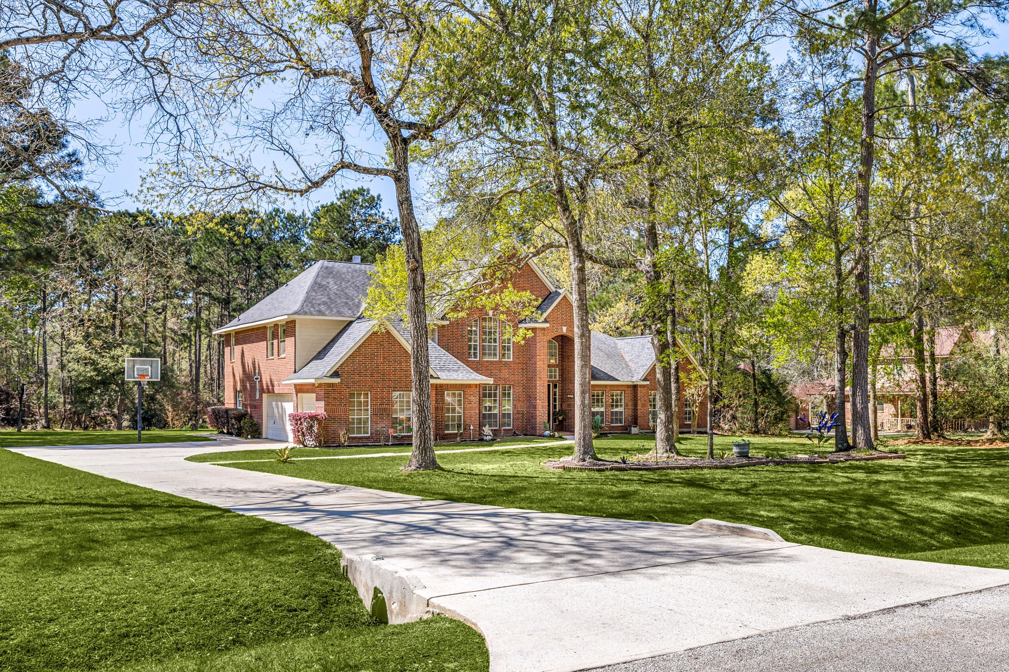 14419 Timbergreen Drive Magnolia, TX 77355 - Photo 2 of 43 Oversized lot with mature trees, long driveway, and beautiful curb appeal. 14419 Timbergreen Drive offers space, privacy, and a peaceful setting.