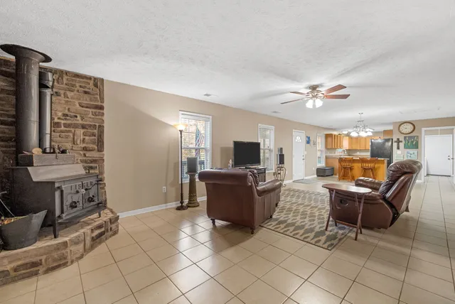 a spacious bedroom with a bed and a chandelier