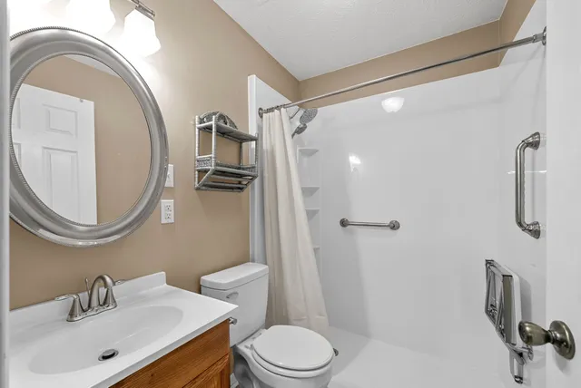 a spacious bedroom with a bed and a chandelier