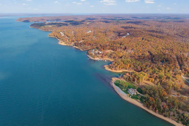 an aerial view of a house with a lake view