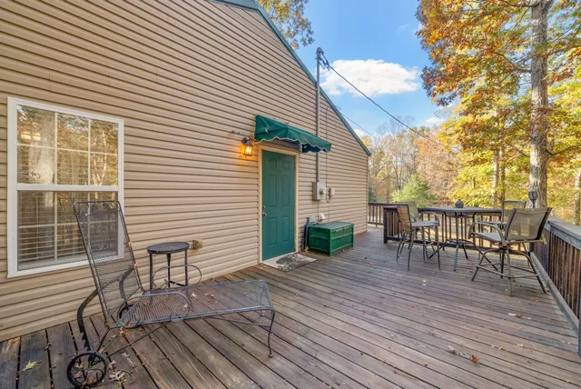 a view of house with backyard and trees