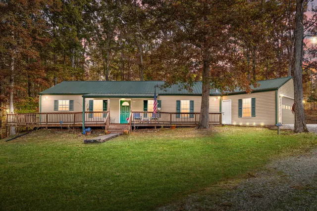 a view of a house with backyard sitting area and garden