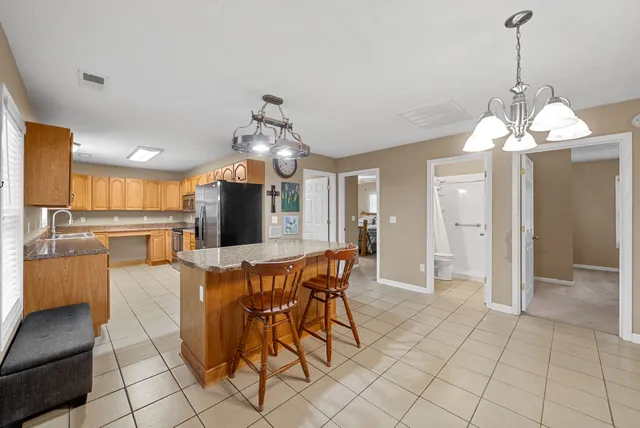 a view of a dining room with furniture and chandelier