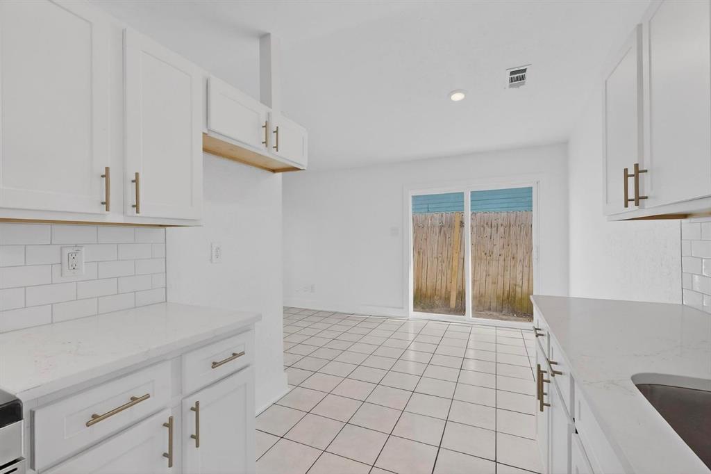 9918 Cedar Mountain Circle Dallas, TX 75217 - Photo 10 of 23 a view of an empty room with cabinets