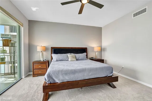 a bedroom with a bed and a lamp