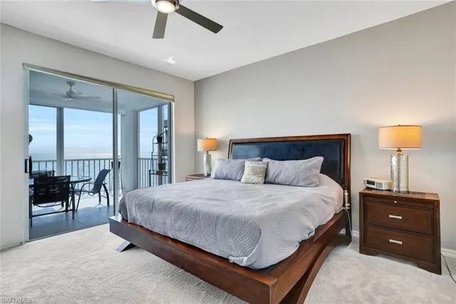 a bedroom with a bed a table and a chandelier