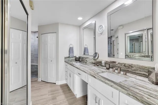 a bathroom with a double vanity sink and mirror