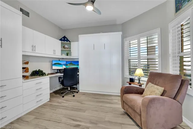 a view of a livingroom with workspace and a window
