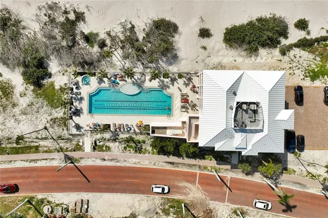 an aerial view of a house with a yard and a large tree