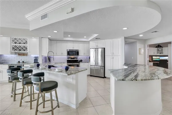 a kitchen with stainless steel appliances kitchen island granite countertop a sink and cabinets