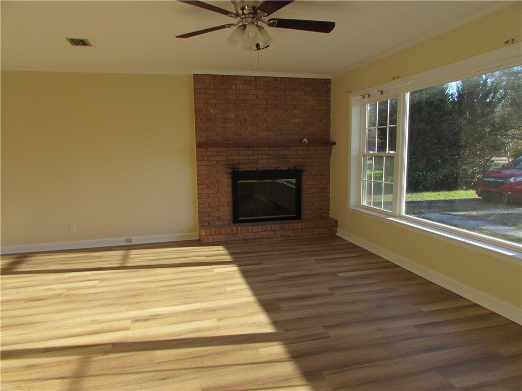 3540 Williams Street Patterson, GA 31557 - Photo 4 of 22 The main living room has a large window and wood burning fireplace. All windows in the house have been replaced.