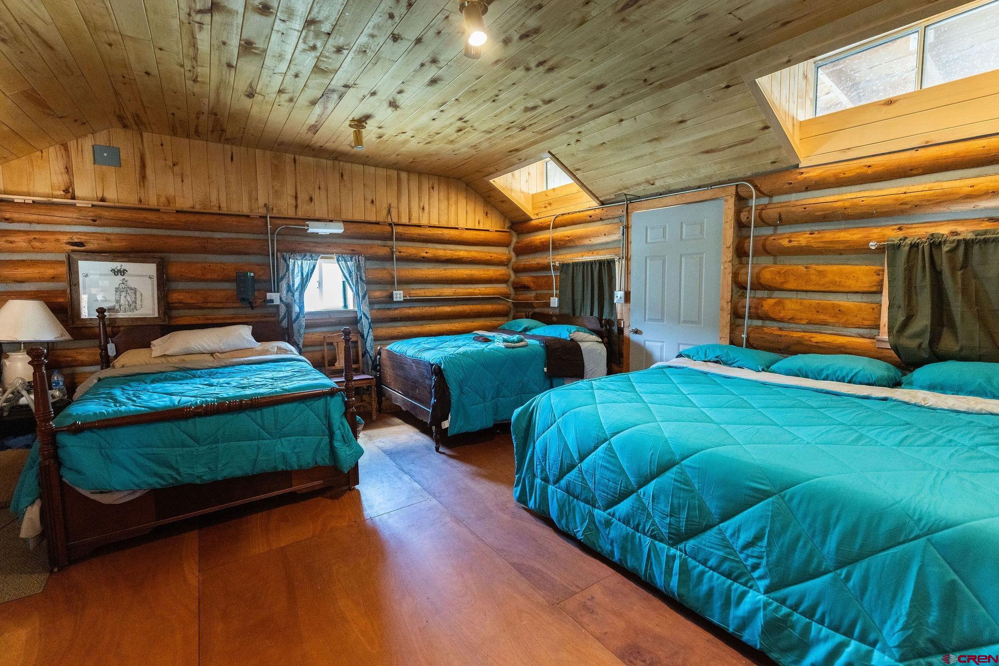 4650 Usfs Rd 516 Creede, CO 81130 - Photo 18 of 33 a bedroom with two beds and next to a window