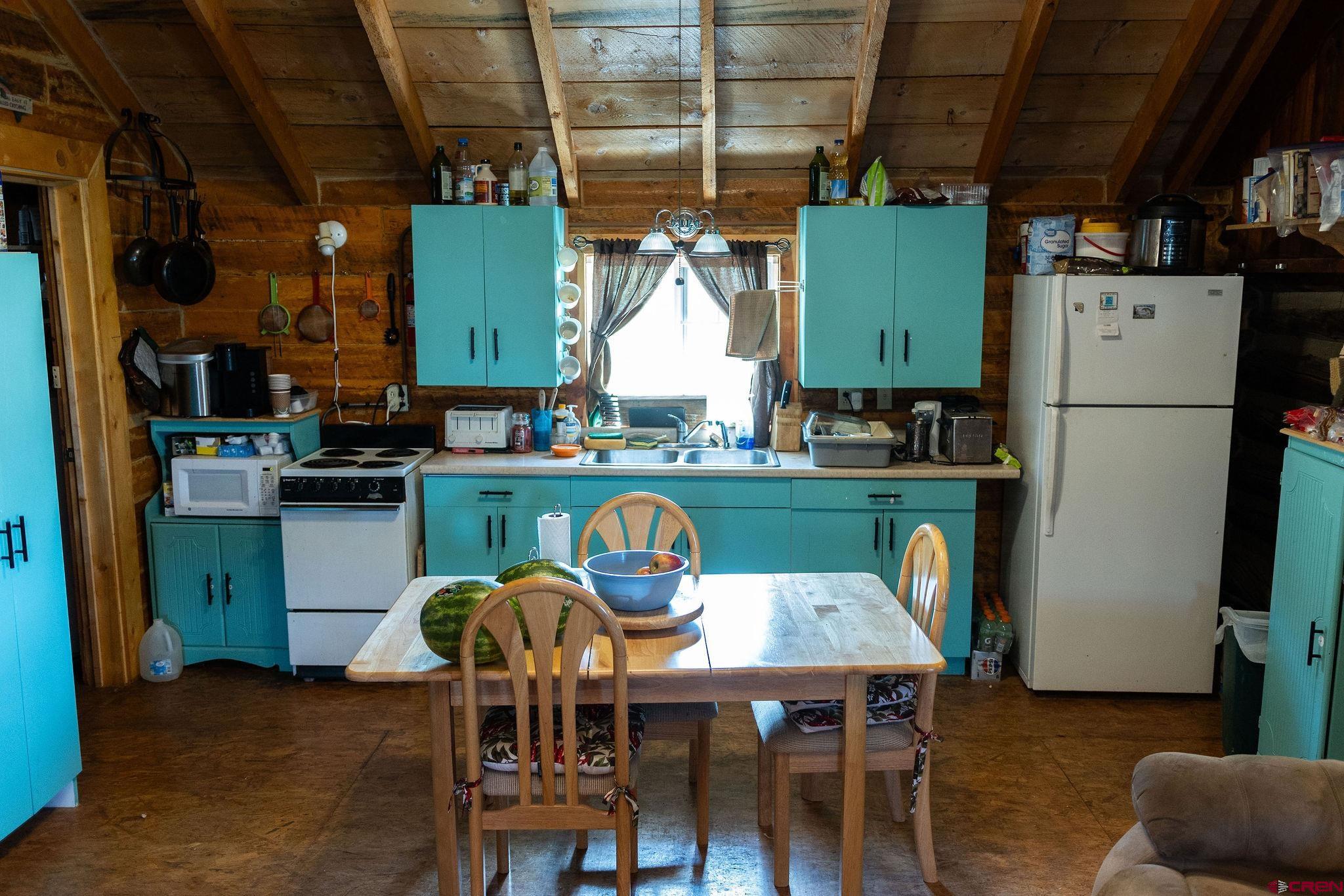 4650 Usfs Rd 516 Creede, CO 81130 - Photo 21 of 33 a dining room with furniture and a refrigerator