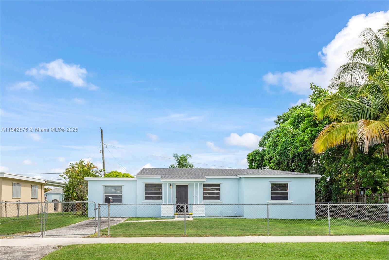 16921 Southwest 302nd Terrace Homestead, FL 33030 - Photo 2 of 14 a view of a big house with a big yard and potted plants