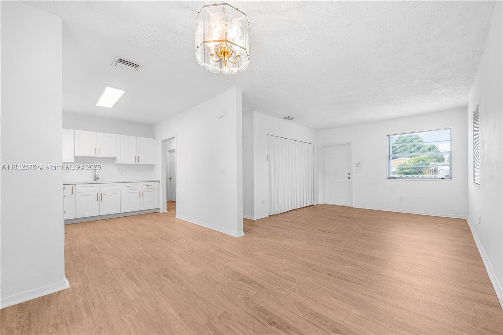 16921 Southwest 302nd Terrace Homestead, FL 33030 - Photo 5 of 14 a view of an empty room and a window