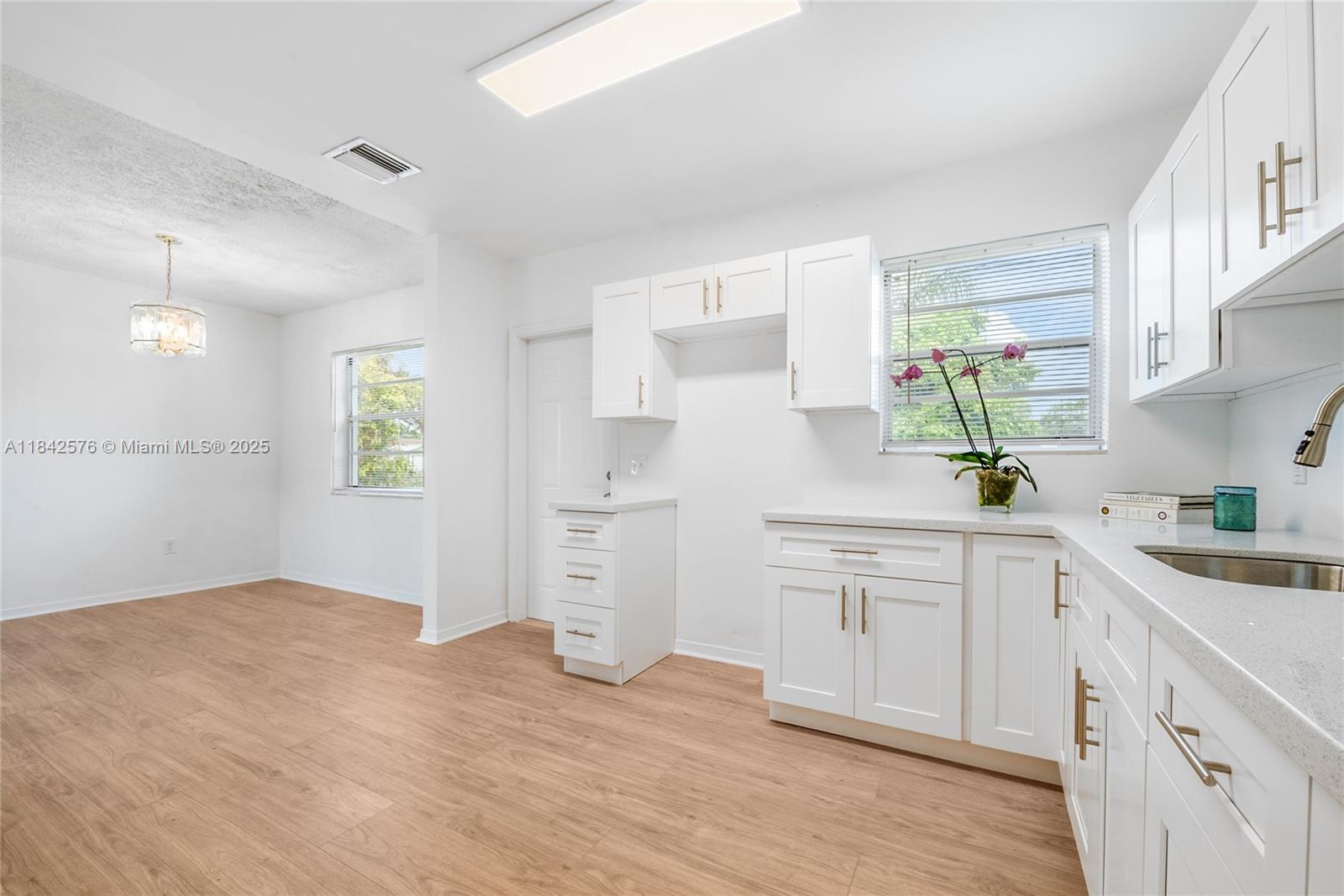 16921 Southwest 302nd Terrace Homestead, FL 33030 - Photo 6 of 14 a kitchen with white cabinets and appliances