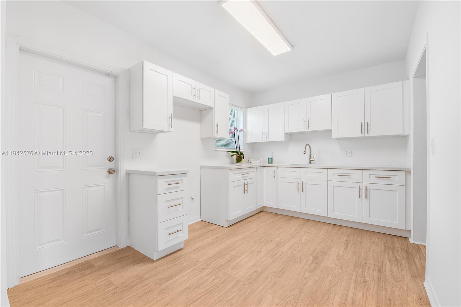 16921 Southwest 302nd Terrace Homestead, FL 33030 - Photo 7 of 14 a kitchen with white cabinets white stainless steel appliances and sink