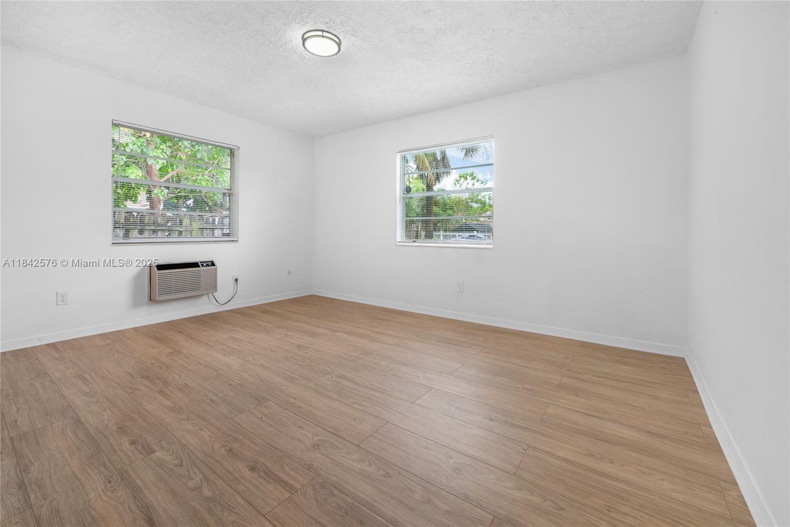 16921 Southwest 302nd Terrace Homestead, FL 33030 - Photo 8 of 14 wooden floor in an empty room with a window
