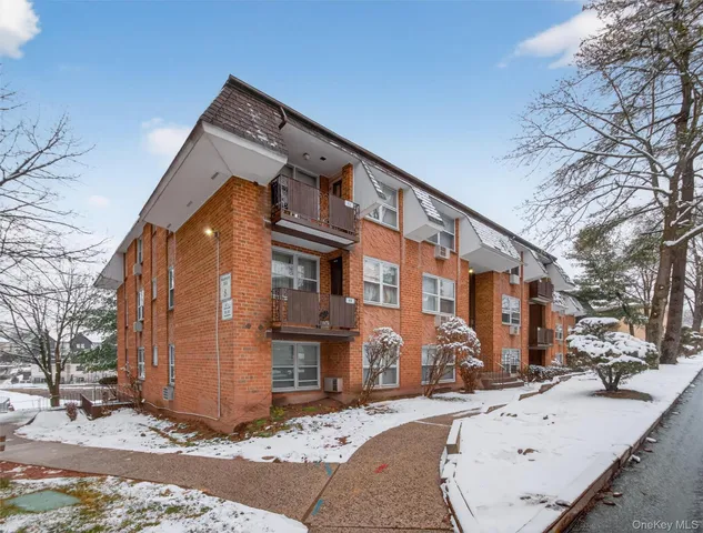a view of an empty room with wooden and a window