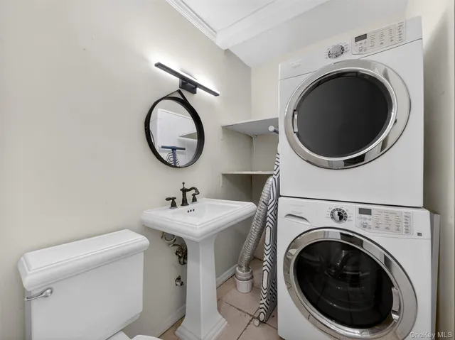 a bathroom with a sink mirror and toilet