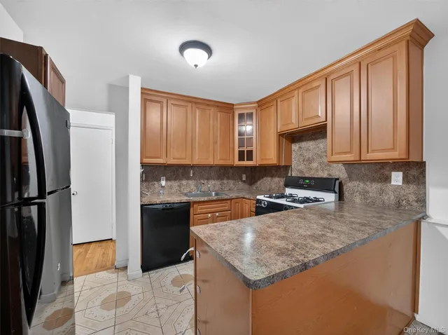 a kitchen with stainless steel appliances granite countertop a refrigerator sink and cabinets