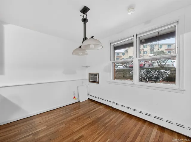a view of a kitchen with a sink and wooden floor